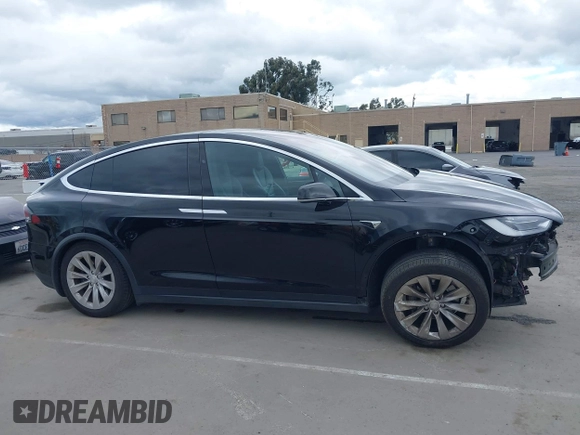 2017 Tesla Model X 90D with VIN 5YJXCAE2XHF075341, listed as a IAAI auction lot 41784008 with 77,439 mi miles and . Bid and sale history available at DreamBid. Image 14.