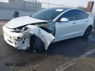 2021 Tesla Model 3 Long Range with VIN 5YJ3E1EB0MF009965, listed as a IAAI auction lot 41478233 with 31,713 mi miles and . Bid and sale history available at DreamBid. Image 2.