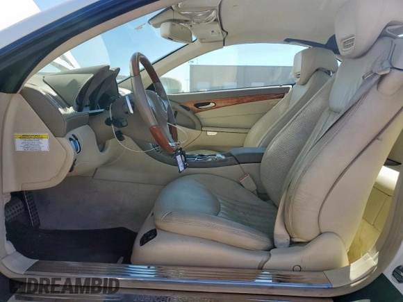 2009 Mercedes-Benz SL 550 with VIN WDBSK71F69F147589, listed as a Copart auction lot 65976995 with 77,387 mi miles and Salvage title. Bid and sale history available at DreamBid. Image 7.