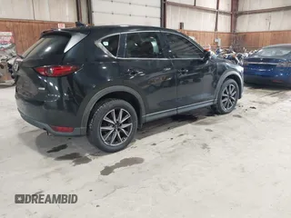 2017 Mazda CX-5 Grand Touring with VIN JM3KFBDL6H0143013, listed as a IAAI auction lot 41912979 with 122,890 mi miles. Bid and sale history available at carsss.com. Image 4.