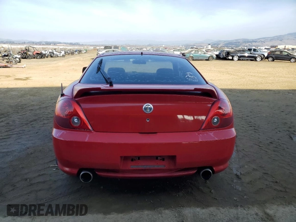 2003 Hyundai Tiburon GT z VIN KMHHN65F63U060104, wystawiony jako Copart lot #84560184 z przebiegiem 160 120 mil mil oraz Czysty tytuł • Clean title. Historia ofert i sprzedaży dostępna na DreamBid. Obrazek 6.