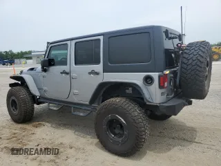 2013 Jeep Wrangler Unlimited Rubicon with VIN 1C4BJWFG5DL661282, listed as a Copart auction lot 57471035 with 128,400 mi miles and Salvage title. Bid and sale history available at DreamBid. Image 2.