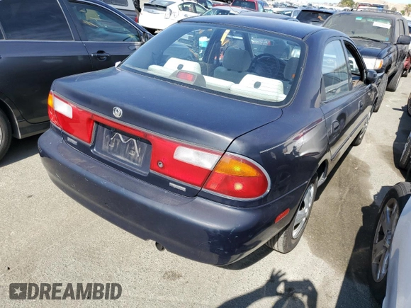 1997 Mazda Protege DX z VIN JM1BC1412V0157268, wystawiony jako Copart lot #61380564 z przebiegiem 85 356 mil mil oraz Szkoda całkowita • Salvage title. Historia ofert i sprzedaży dostępna na DreamBid. Obrazek 3.