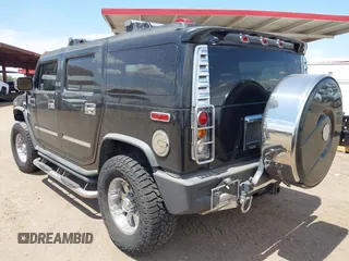 2003 Hummer H2 with VIN 5GRGN23U73H122756, listed as a IAAI auction lot 42194176 with 239,411 mi miles. Bid and sale history available at carsss.com. Image 3.