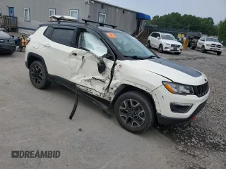 2019 Jeep Compass Trailhawk with VIN 3C4NJDDB5KT671613, listed as a Copart auction lot 61023125 with 64,793 mi miles and Salvage title. Bid and sale history available at DreamBid. Image 4.