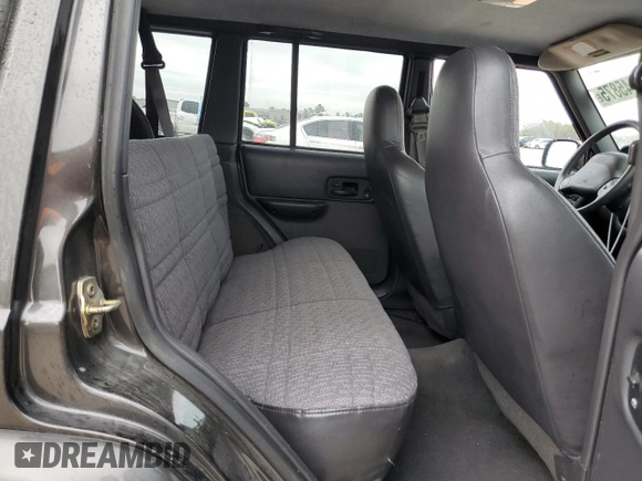1999 Jeep Cherokee Sport with VIN 1J4FT68S2XL656679, listed as a Copart auction lot 88145875 with 254,038 mi miles and Salvage title. Bid and sale history available at DreamBid. Image 11.