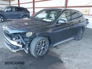 2021 BMW X1 xDrive28i with VIN WBXJG9C02M5T41170, listed as a IAAI auction lot 41886408 with 56,316 mi miles. Bid and sale history available at carsss.com. Image 2.