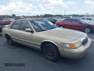 1999 Mercury Grand Marquis LS z VIN 2MEFM75W7XX665959, wystawiony jako IAAI lot #42187818 z przebiegiem 123 126 mil mil oraz . Historia ofert i sprzedaży dostępna na DreamBid. Obrazek 1.