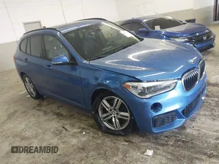 2019 BMW X1 xDrive28i with VIN WBXHT3C53K5L36690, listed as a IAAI auction lot 42012992 with 70,339 mi miles. Bid and sale history available at carsss.com. Image 1.