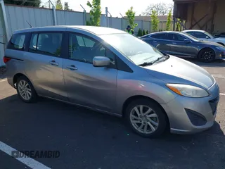 2012 Mazda 5 Sport z VIN JM1CW2BL3C0115906, wystawiony jako IAAI lot #42062899 z przebiegiem 124 286 mil mil oraz . Historia ofert i sprzedaży dostępna na DreamBid. Obrazek 1.