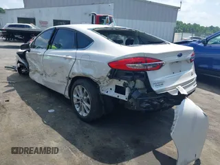 2020 Ford Fusion SE z VIN 3FA6P0LU5LR153942, wystawiony jako IAAI lot #42145638 z przebiegiem 99 961 mil mil oraz . Historia ofert i sprzedaży dostępna na DreamBid. Obrazek 3.