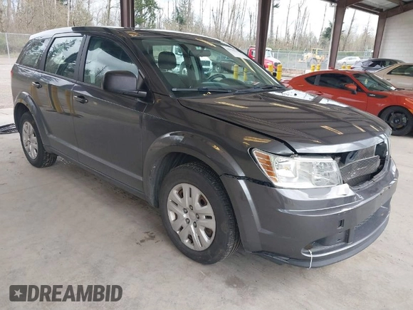 2015 Dodge Journey SE z VIN 3C4PDCAB1FT617794, wystawiony jako IAAI lot #41922371 z przebiegiem 130 558 mil mil oraz . Historia ofert i sprzedaży dostępna na DreamBid. Obrazek 1.