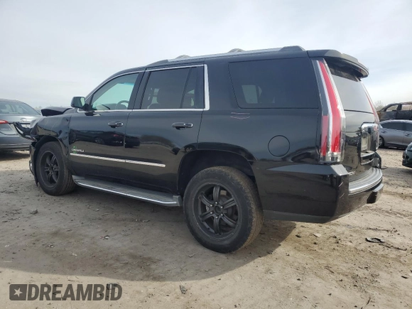 2015 GMC Yukon Denali with VIN 1GKS1CKJ1FR303049, listed as a Copart auction lot 82435514 with 100,693 mi miles and Salvage Title. Bid and sale history available at carsss.com. Image 2.