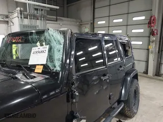 2011 Jeep Wrangler Unlimited Sahara with VIN 1J4HA5H12BL557059, listed as a IAAI auction lot 41856882 with 150,683 mi miles. Bid and sale history available at carsss.com. Image 6.