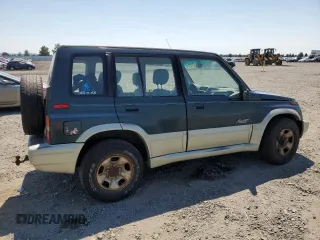 1998 Suzuki Sidekick z VIN JS3TD21V9W4103914, wystawiony jako Copart lot #62112514 z przebiegiem 394 872 mil mil oraz Szkody całkowita. Historia ofert i sprzedaży dostępna na DreamBid. Obrazek 3.
