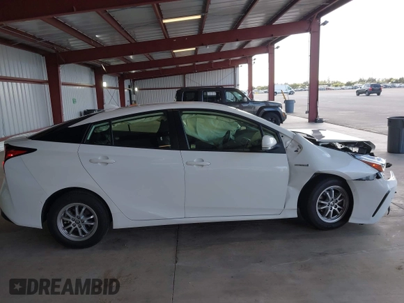 2021 Toyota Prius L Eco z VIN JTDKAMFU5M3146342, wystawiony jako IAAI lot #42249219 z przebiegiem 49 810 mil mil oraz . Historia ofert i sprzedaży dostępna na DreamBid. Obrazek 13.