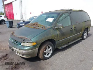 1999 Plymouth Voyager Grand SE z VIN 1P4GP44G0XB579719, wystawiony jako IAAI lot #41981925 z przebiegiem 163 940 mil mil oraz . Historia ofert i sprzedaży dostępna na DreamBid. Obrazek 2.