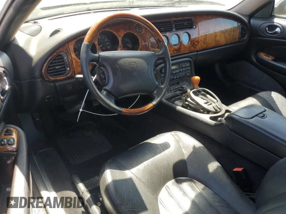 1997 Jaguar XK with VIN SAJGX5740VC014035, listed as a Copart auction lot 53066215 with 140,692 mi miles and Salvage Title. Bid and sale history available at DreamBid. Image 8.