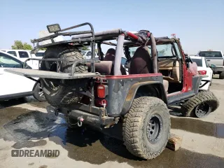 1999 Jeep Wrangler Sport with VIN 1J4FY19S5XP493117, listed as a Copart auction lot 57490792 with Not provided miles and Salvage title. Bid and sale history available at DreamBid. Image 4.