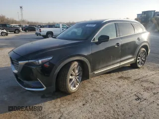 2021 Mazda CX-9 Carbon Edition z VIN JM3TCADY1M0516925, wystawiony jako Copart lot #48665665 z przebiegiem Nie podano mil oraz Szkoda całkowita • Salvage title. Historia ofert i sprzedaży dostępna na DreamBid. Obrazek 1.