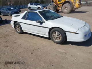 1986 Pontiac Fiero z VIN 1G2PF3790GP231392, wystawiony jako IAAI lot #41870267 z przebiegiem 156 718 mil mil oraz . Historia ofert i sprzedaży dostępna na DreamBid. Obrazek 1.