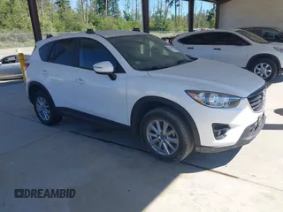 2016 Mazda CX-5 Touring z VIN JM3KE4CY9G0910749, wystawiony jako IAAI lot #42430654 z przebiegiem 88 132 mil mil oraz . Historia ofert i sprzedaży dostępna na DreamBid. Obrazek 1.