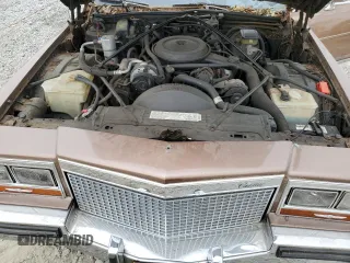 1988 Cadillac Brougham z VIN 1G6DW51Y5J9727006, wystawiony jako Copart lot #70573614 z przebiegiem 34 628 mil mil oraz Szkody całkowita. Historia ofert i sprzedaży dostępna na DreamBid. Obrazek 11.