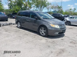 2013 Honda Odyssey Touring with VIN 5FNRL5H96DB068843, listed as a IAAI auction lot 42312176 with 115,804 mi miles and . Bid and sale history available at DreamBid. Image 1.