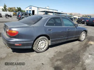 1997 Mazda Millenia z VIN JM1TA2213V1308406, wystawiony jako Copart lot #74141674 z przebiegiem 205 115 mil mil oraz Tytuł czysty. Historia ofert i sprzedaży dostępna na DreamBid. Obrazek 3.