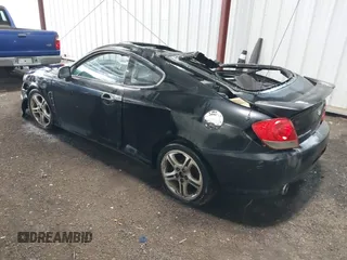 2005 Hyundai Tiburon GT z VIN KMHHN65F45U184777, wystawiony jako IAAI lot #42190342 z przebiegiem 213 013 mil mil oraz . Historia ofert i sprzedaży dostępna na DreamBid. Obrazek 3.