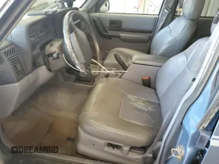 1998 Jeep Cherokee Country with VIN 1J4FT78S8WL252502, listed as a Copart auction lot 59664545 with 133,148 mi miles and Salvage title. Bid and sale history available at DreamBid. Image 7.