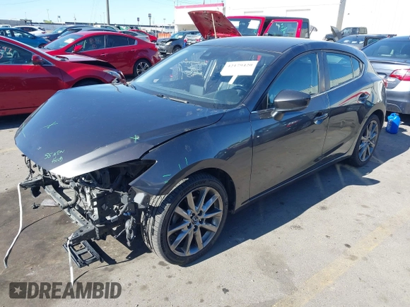 2018 Mazda 3 Touring with VIN 3MZBN1L34JM164952, listed as a IAAI auction lot 42179420 with 106,706 mi miles and . Bid and sale history available at DreamBid. Image 2.
