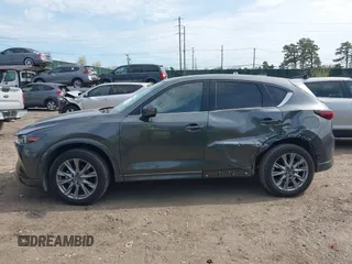 2024 Mazda CX-5 S Premium z VIN JM3KFBDLXR0486618, wystawiony jako IAAI lot #42055952 z przebiegiem 4559 mil mil oraz . Historia ofert i sprzedaży dostępna na DreamBid. Obrazek 14.