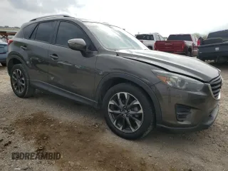 2016 Mazda CX-5 Grand Touring z VIN JM3KE2DY7G0735355, wystawiony jako Copart lot #49438285 z przebiegiem 132 731 mil mil oraz Szkoda całkowita • Salvage title. Historia ofert i sprzedaży dostępna na DreamBid. Obrazek 4.