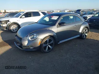 2012 Volkswagen Beetle 2.0T Turbo w/Sun/Snd/Nav PZEV with VIN 3VWVA7AT4CM628968, listed as a IAAI auction lot 41847614 with 71,813 mi miles. Bid and sale history available at carsss.com. Image 2.