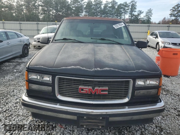 1999 GMC Yukon with VIN 1GKEC13R7XJ802387, listed as a Copart auction lot 82819934 with 438,574 mi miles and Salvage Title. Bid and sale history available at carsss.com. Image 5.
