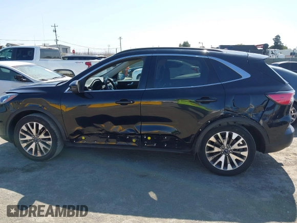 2020 Ford Escape Titanium z VIN 1FMCU9J97LUB18350, wystawiony jako IAAI lot #42574736 z przebiegiem 82 551 mil mil oraz . Historia ofert i sprzedaży dostępna na DreamBid. Obrazek 15.