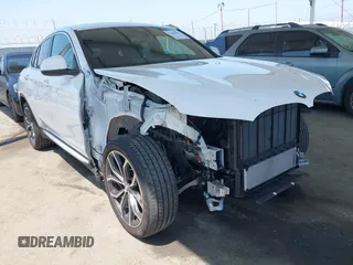 2024 BMW X4 xDrive30i with VIN 5UX33DT03R9T66002, listed as a IAAI auction lot 42444282 with 19,451 mi miles and . Bid and sale history available at DreamBid. Image 1.