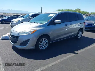 2015 Mazda 5 Sport z VIN JM1CW2BL3F0185779, wystawiony jako IAAI lot #42609991 z przebiegiem 158 403 mil mil oraz . Historia ofert i sprzedaży dostępna na DreamBid. Obrazek 2.