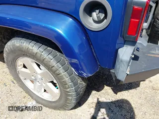 2009 Jeep Wrangler Sahara z VIN 1J4FA54199L722192, wystawiony jako IAAI lot #41619305 z przebiegiem 105 545 mil mil oraz . Historia ofert i sprzedaży dostępna na DreamBid. Obrazek 18.