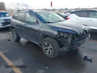 2015 Jeep Cherokee Trailhawk with VIN 1C4PJMBS9FW785545, listed as a IAAI auction lot 41573197 with 124,304 mi miles. Bid and sale history available at carsss.com. Image 1.