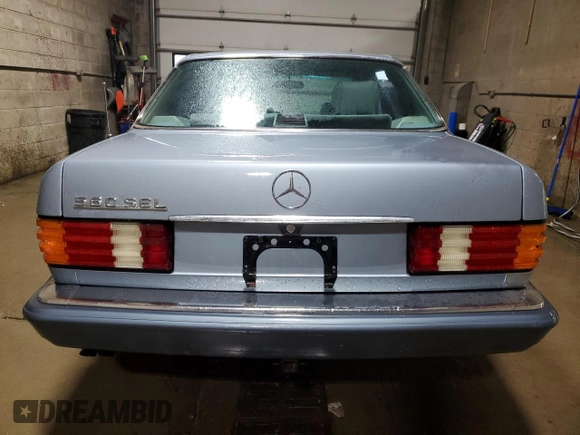 1986 Mercedes-Benz 560 with VIN WDBCA39DXGA213770, listed as a Copart auction lot 49787355 with 218,547 mi miles and Salvage Title. Bid and sale history available at DreamBid. Image 6.