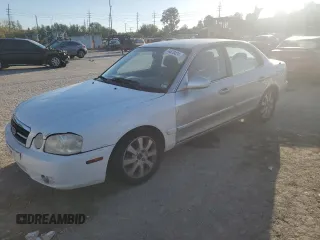 2005 Kia Optima LX z VIN KNAGD128255410933, wystawiony jako Copart lot #74470424 z przebiegiem 152 898 mil mil oraz Czysty tytuł • Clean title. Historia ofert i sprzedaży dostępna na DreamBid. Obrazek 1.