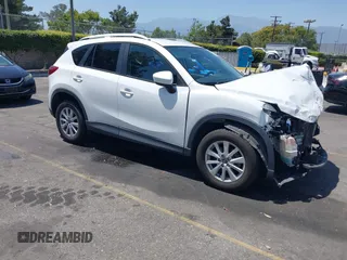 2014 Mazda CX-5 Touring with VIN JM3KE2CY2E0307059, listed as a IAAI auction lot 42532884 with 101,896 mi miles and . Bid and sale history available at DreamBid. Image 1.