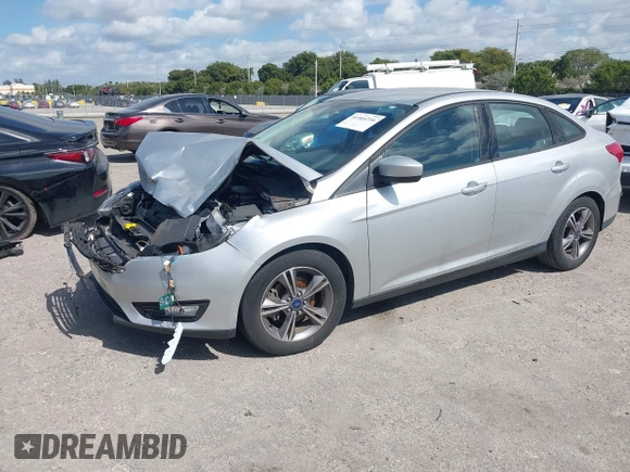2018 Ford Focus SE z VIN 1FADP3FE3JL220529, wystawiony jako IAAI lot #41564216 z przebiegiem 16 883 mil mil oraz . Historia ofert i sprzedaży dostępna na DreamBid. Obrazek 2.