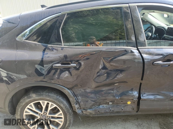 2021 Ford Escape SEL Hybrid z VIN 1FMCU9CZ7MUA94260, wystawiony jako Copart lot #71013514 z przebiegiem Nie podano mil oraz Szkoda całkowita • Salvage title. Historia ofert i sprzedaży dostępna na DreamBid. Obrazek 11.