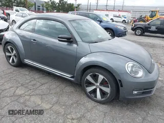 2012 Volkswagen Beetle 2.0T Turbo w/Sun/Snd/Nav PZEV with VIN 3VWVA7AT5CM653829, listed as a IAAI auction lot 42121383 with 114,474 mi miles. Bid and sale history available at carsss.com. Image 1.