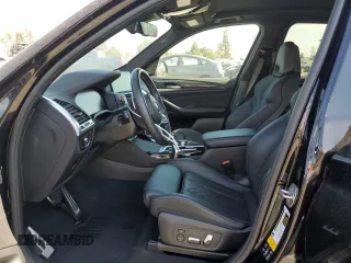 2021 BMW X3 M with VIN 5YMTS0C05M9F31855, listed as a Copart auction lot 71724374 with 30,814 mi miles and Salvage Title. Bid and sale history available at carsss.com. Image 7.