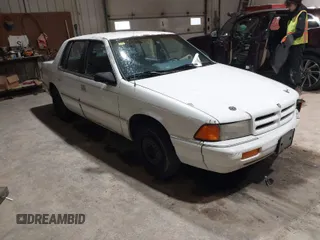 1994 Dodge Spirit z VIN 3B3AA46KXRT214299, wystawiony jako IAAI lot #41908262 z przebiegiem 72 619 mil mil oraz . Historia ofert i sprzedaży dostępna na DreamBid. Obrazek 1.