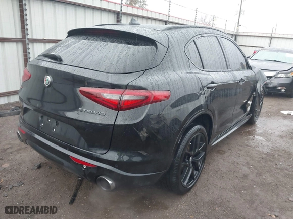 2021 Alfa Romeo Stelvio Ti with VIN ZASPAKBN0M7D02795, listed as a IAAI auction lot 41052309 with 83,584 mi miles. Bid and sale history available at carsss.com. Image 4.